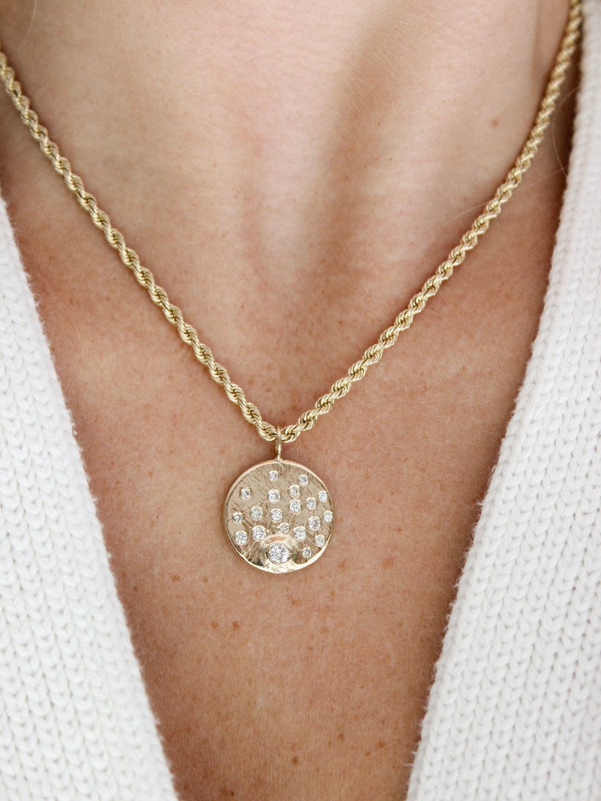 Custom diamond disc pendant necklace hand-carved in gold and designed as an heirloom piece.