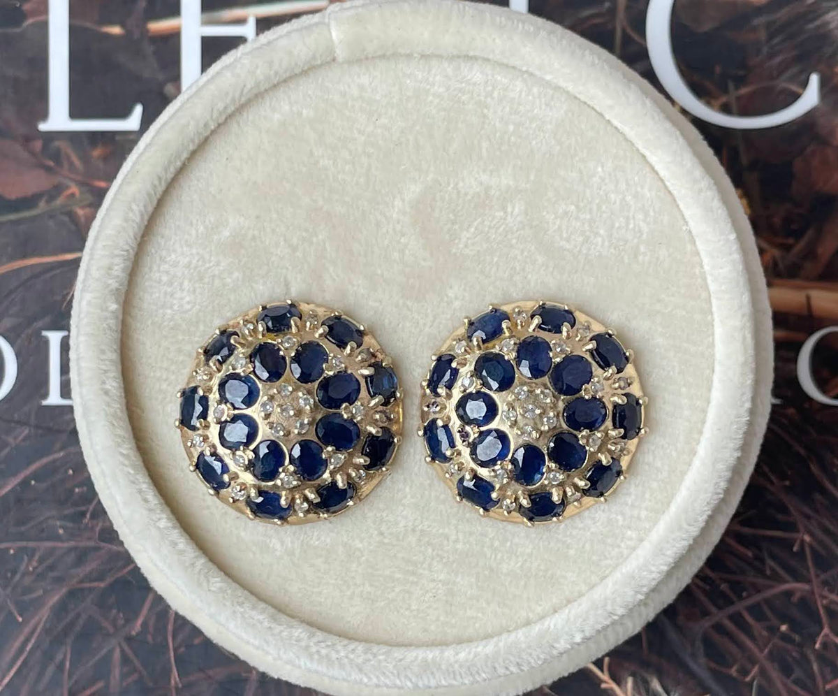 Custom sapphire and diamond stud earrings set in hand-carved gold.