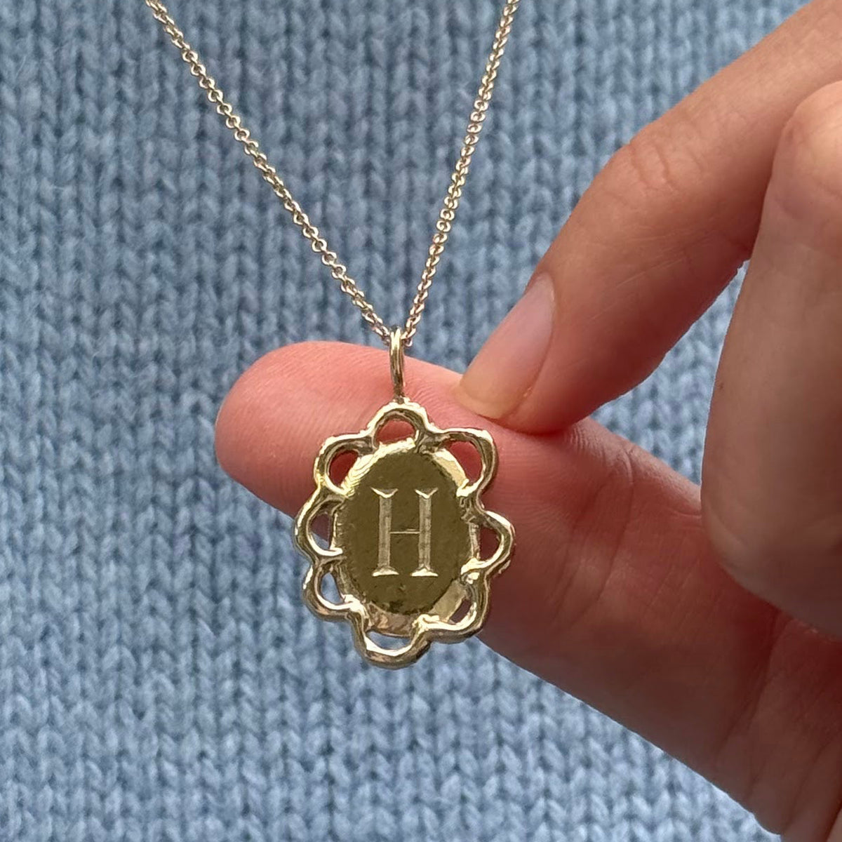 Gold Scallop Pendant engraved with the letter H on a chain