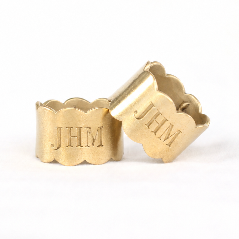 Set of hand-carved brass Scallop Napkin Rings with a digital rendering of a laser-engraved monogram