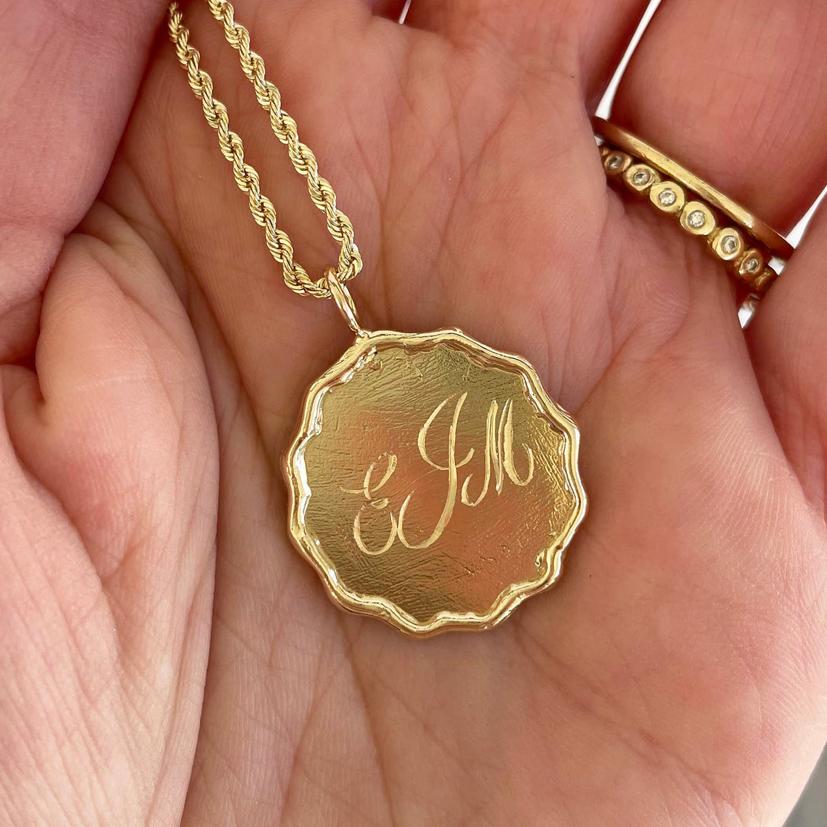Gold Wavy Disc Pendant hand-engraved with a monogram on the front